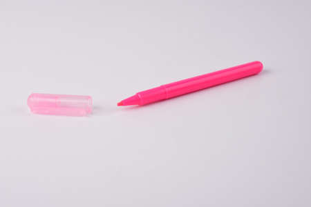 Pink pen on a white background. The concept of education and creativity.の写真素材