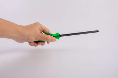 screwdriver tools in hand on white backgroundの写真素材