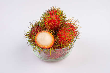 Rambutan fruit in glass cup on white backgroundの写真素材