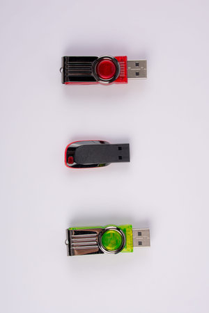 Three portable usb flash drives or memory sticks on white background