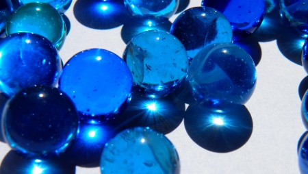 Blue marbles with light shining throughの写真素材