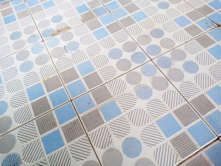An old ceramic tile floor with a blue pattern can be used as a texture backgroundの写真素材