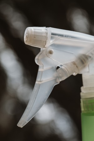 green water spray for indoor plants on a dark background.の写真素材