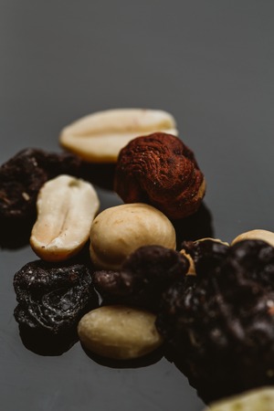 mixture of nuts and dried fruits on a dark background.の写真素材