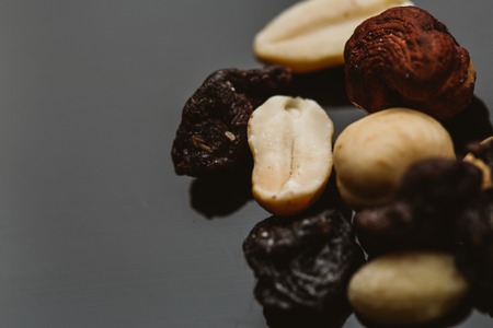 mixture of nuts and dried fruits on a dark background.の写真素材