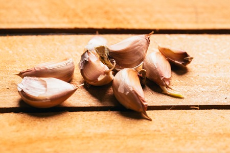 slices of garlic on a light wooden background.の写真素材