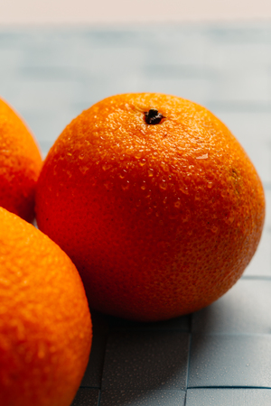 fresh tangerines on a light blue background close-up.の写真素材
