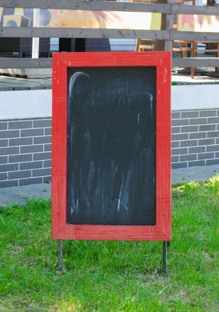 Menu blank board with a street cafe or restaurant in the backgroundの写真素材