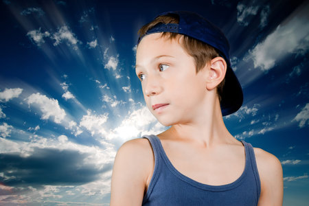 young boy over blue radious skyの写真素材