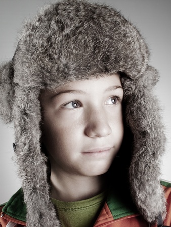 smiling caucasian child with warm hatの写真素材