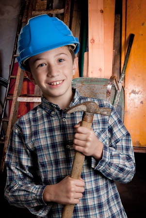 child with blue helmet and hammerの写真素材