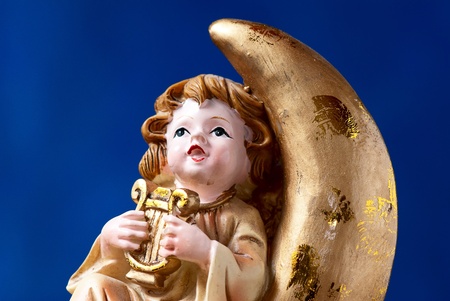 angel plays harp on blue backgroundの写真素材