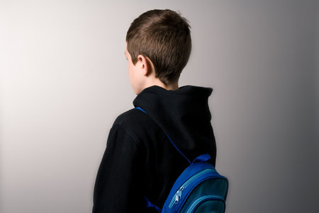 boy with a sweatshirt and backpack at the start