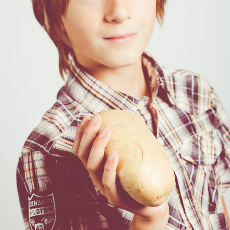 child with big potatoesの写真素材