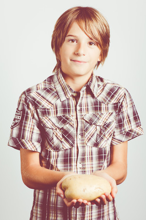 child with big potatoesの写真素材