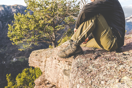 hiker standing on the rocks and contemplates a beautiful mountain landscape -wanderlust travel concept with sporty people at excursion in wild nature - outdoor activity italian Alps Italyの写真素材