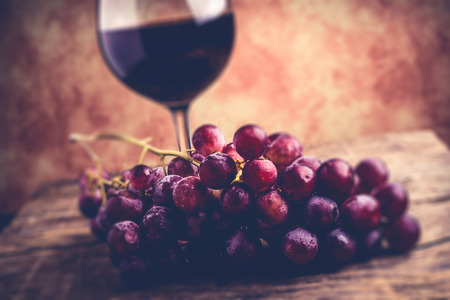 grapes red globe an wine glassの写真素材