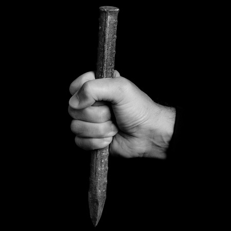 chisel - tools in a man's hand - black and white photoの写真素材