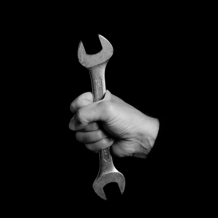 spanner - tools in a man's hand - black and white photoの写真素材