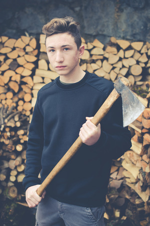 young boy prepares firewood - vintage style photoの写真素材