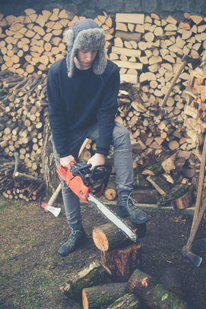 young boy prepares firewood - vintage style photoの写真素材