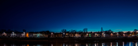 riverfront homes at dusk - italian landscape panoramaの写真素材