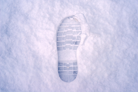 human boot footprint on the snowの写真素材