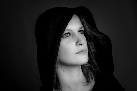 portrait of hooded woman - black and white imageの写真素材