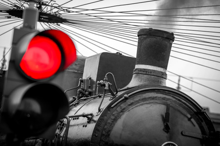 old train with red traffic light - black and white imageの写真素材