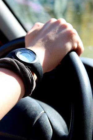 Detail of female hand on the steering wheel of a carの写真素材