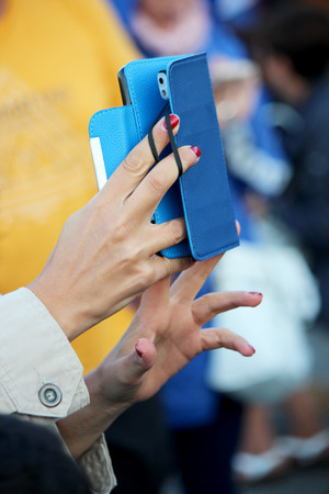 woman takes a photo with a smarphoneの写真素材