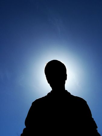 A photograph of my brother with the sun behind himの写真素材