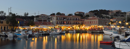 Holiday makers dining in harbor side restaurants Molyvos Greeceのeditorial素材