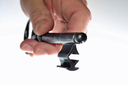 Hand holding old as if to open a door white backgroundの写真素材