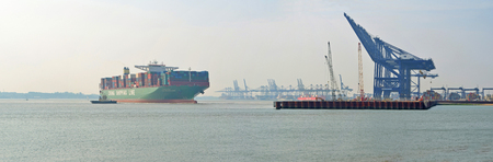 China Shippings Container vessel CSCL Atlantic Ocean pulling away from Felixstowe port tugs helping.のeditorial素材