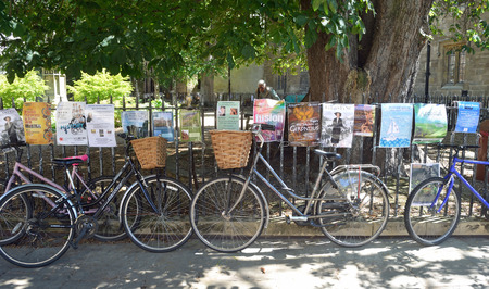 Bicycles and posters attached to railingsのeditorial素材