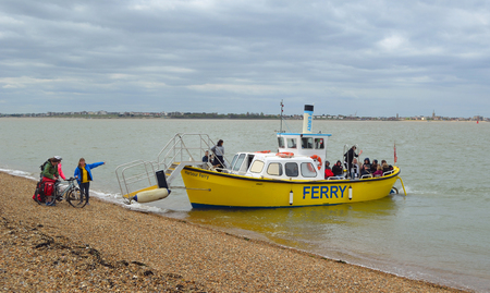 FELIXSTOWE, SUFFOLK, ENGLAND - APRIL 16, 2017: People boarding the Ferry across the estuary of the river Orwell from Felixstowe to Harwich, Dovercourt in the background.のeditorial素材