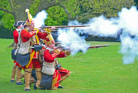 SAFFRON WALDEN, ESSEX, ENGLAND - MAY 01, 2017:  The Redcoats of  Pulteneys  Regiment firing their...