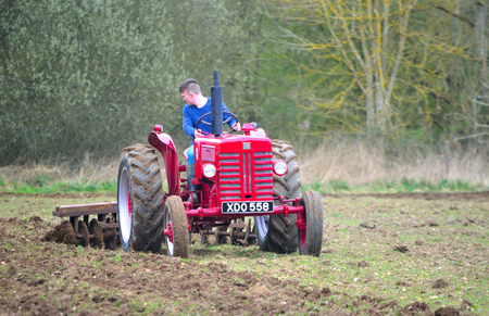 ST NEOTS, CAMBRIDGESHIRE, ENGLAND - MARCH 19, 2017: Vintage red International 1960's  tractor ploughing field.のeditorial素材
