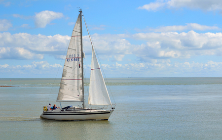 FELIXSTOWE, SUFFOLK, ENGLAND - AUGUST 29, 2016: Yacht leaving Felixstowe Ferry at the mouth of the river Deben.のeditorial素材