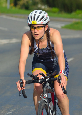 GRAFHAM, CAMBRIDGESHIRE, ENGLAND - AUGUST 06, 2017: Close up of Female Triathlete on road cycling stage of triathlon.のeditorial素材