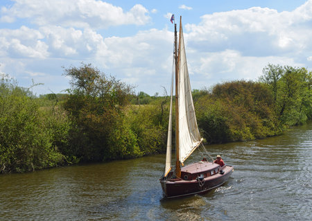 HORNING, NORFOLK, ENGLAND - MAY 10, 2018:  Old Fashioned Yacht  under sail navigating  the river...