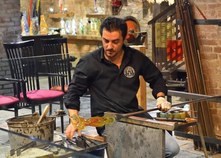 MURANO, VENICE, ITALY - SEPTEMBER 23, 2017: Murano glass worker making vase.のeditorial素材