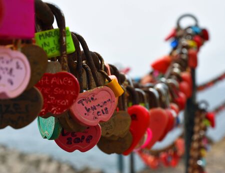 Multi coloured Padlocks on chain fenceのeditorial素材