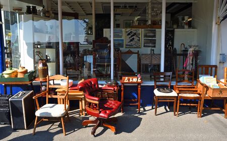FELIXSTOWE, SUFFOLK, ENGLAND - APRIL 21, 2019: Antique Shop with furniture on pavement outside.のeditorial素材