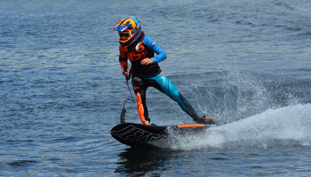 WYBOSTON, BEDFORDSHIRE, ENGLAND - JULY 07, 2019: Female Motorsurf racer moving at speed making a lot...