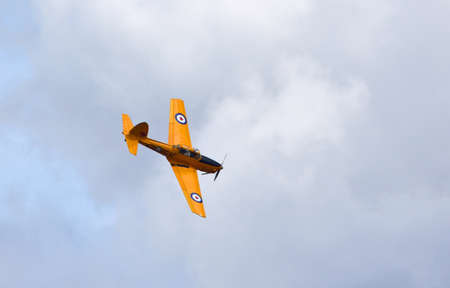 ICKWELL, BEDFORDSHIRE, ENGLAND - AUGUST 02, 2020:  Vintage DHC-1 Chipmunk G-BNZC/RCAF 671 Aircraft in flight  in sunshine with clouds in backgroundのeditorial素材