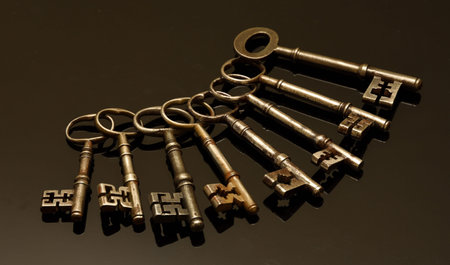 Eight Antique keys on black background