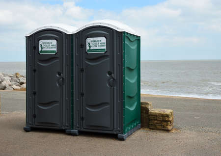 Two Portaloo cubicles on seafront promenade with the ocean in the background.のeditorial素材