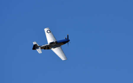 North American P-51D Mustang Aircraft "Miss Helen" flying with blue sky background.のeditorial素材
